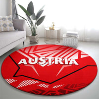 Red round carpet with AUSTRIA wordmark and eagle silhouette center