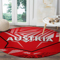 Red round carpet with AUSTRIA lettering and eagle emblem
