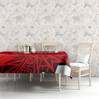 Red tablecloth with Austria emblem on dining table with chairs