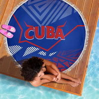 Blue round beach blanket with white fringe, 'CUBA' logo at center, geometric artwork