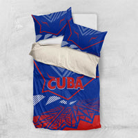 Blue bedding set flat lay with "CUBA" graphic duvet and two coordinated pillows