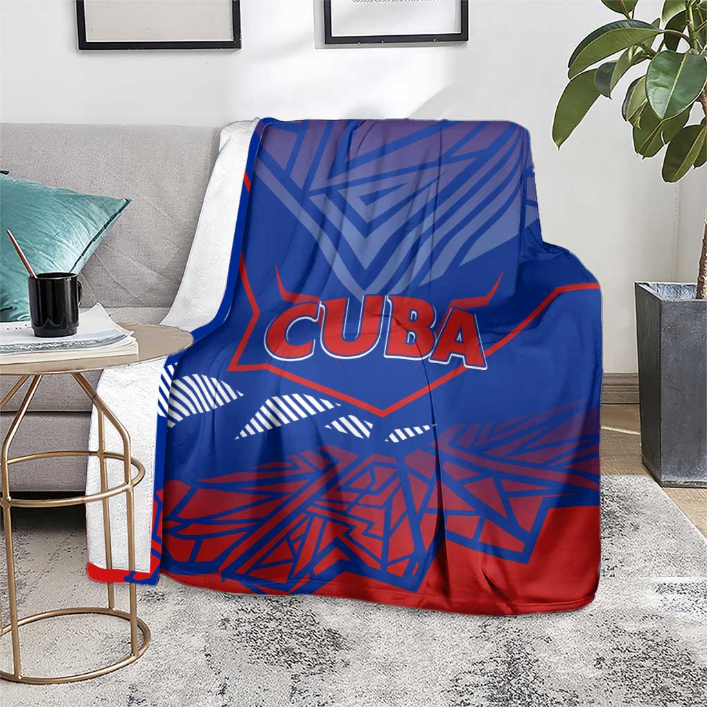Blue Cuba blanket folded over arm with CUBA logo and red/white geometric pattern