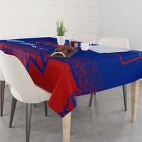 Red and blue geometric tablecloth covering dining table with decor