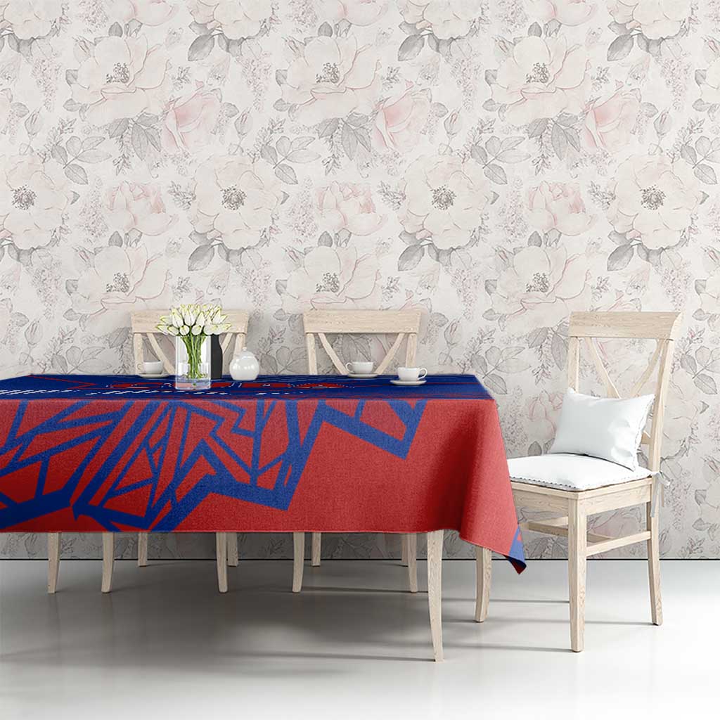 Blue and red geometric tablecloth on long dining table with chairs