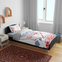 Czechia bedding set on bed: white duvet cover with red/blue geometric accents and pillowcases