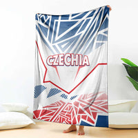 Czechia blanket draped over couch, showing CZECHIA logo and blue/red geometric flag art