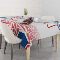 Blue, red and white geometric Czechia-style tablecloth draped over a table edge