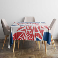 Blue, red and white Czechia-style geometric tablecloth on a table with four chairs