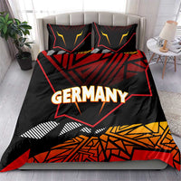 Germany eagle bedding set on bed, black with red and yellow geometric design; "GERMANY"
