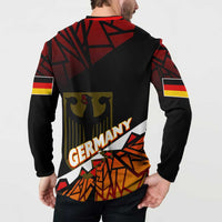 Back of red and black button sweatshirt with Germany text, eagle emblem, and geometric pattern