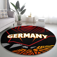 Round black carpet with Germany word graphic, red star and orange accents