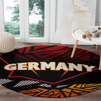 Round black carpet with Germany word graphic, red star and orange geometric border