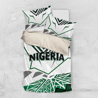 Folded Nigeria bedding set showing white base with green and black geometric flag pattern.