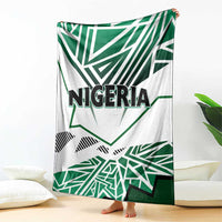 Nigeria flag blanket draped over floor, white and green design with “NIGERIA” lettering