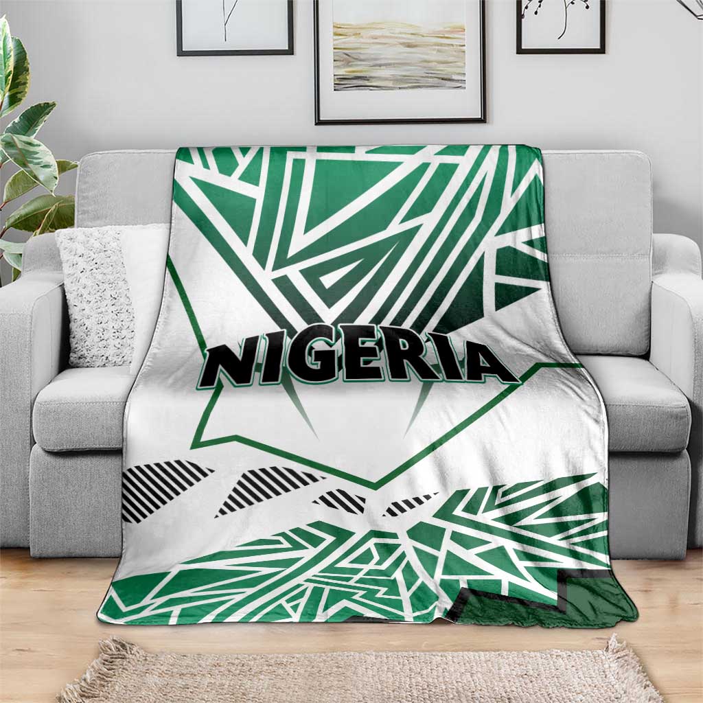 Nigeria flag blanket on sofa, white background with green star shapes and “NIGERIA” text