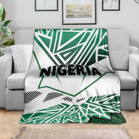 Nigeria flag blanket on sofa, white background with green star shapes and “NIGERIA” text
