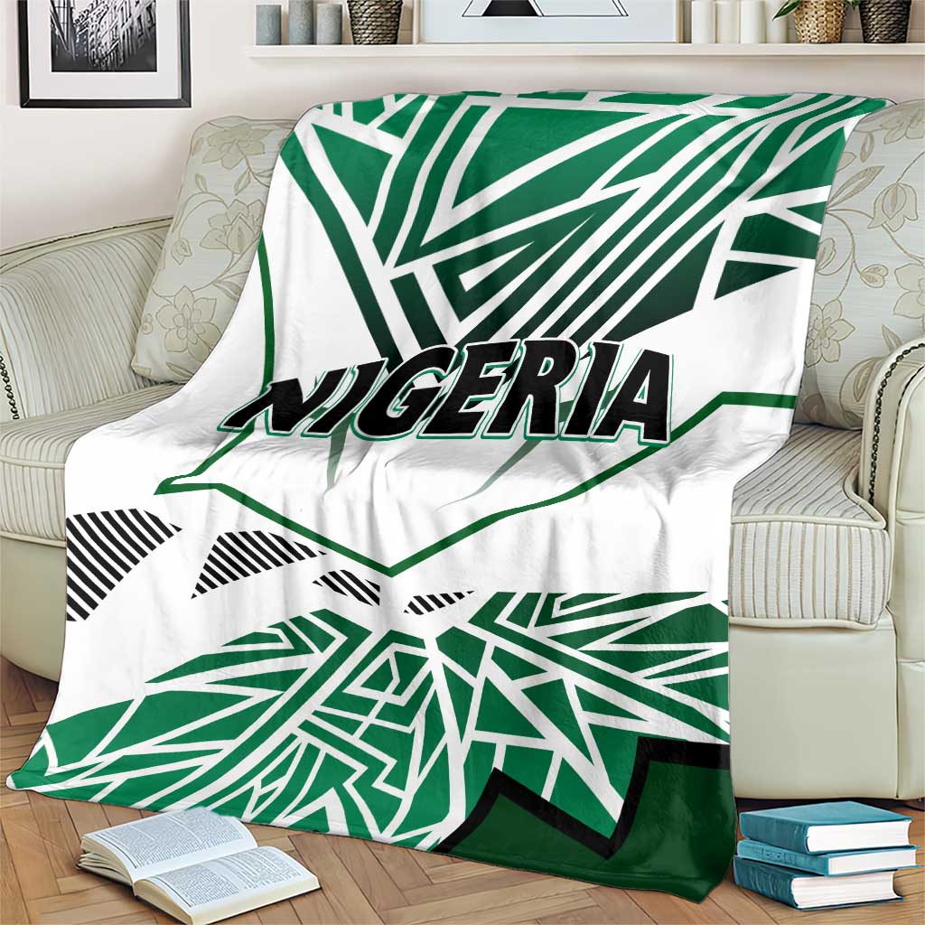 Nigeria flag blanket on armchair, white fabric with green patterned rays and “NIGERIA”