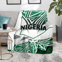 Nigeria flag blanket over couch, white and green geometric print with centered “NIGERIA”