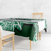 Nigerian flag tablecloth with green-and-white geometric print on long table