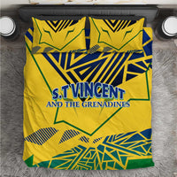 Yellow bedding set with duvet cover and two pillowcases, bold blue-green emblem graphics.