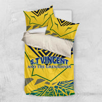 Yellow duvet cover with two pillowcases laid out, blue-green emblem text and geometric print.