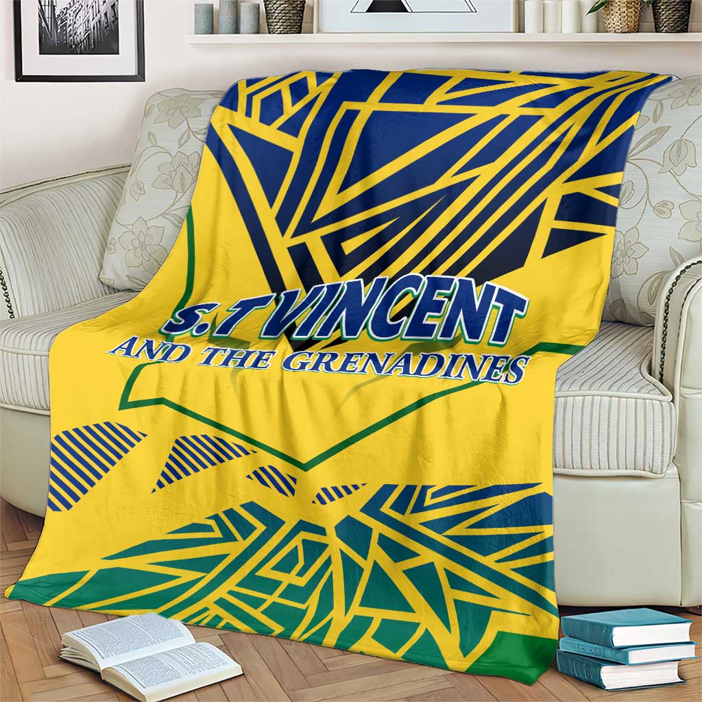 Yellow throw blanket with bold blue geometric top pattern, green accents, and 'S.T.Vincent' text