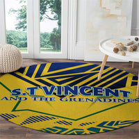 Round yellow rug with blue and green geometric design and S.T. Vincent banner across center