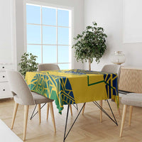 Yellow tablecloth with blue and green geometric pattern draped over dining table