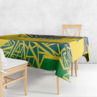 Yellow tablecloth with blue and green geometric pattern over wooden bench