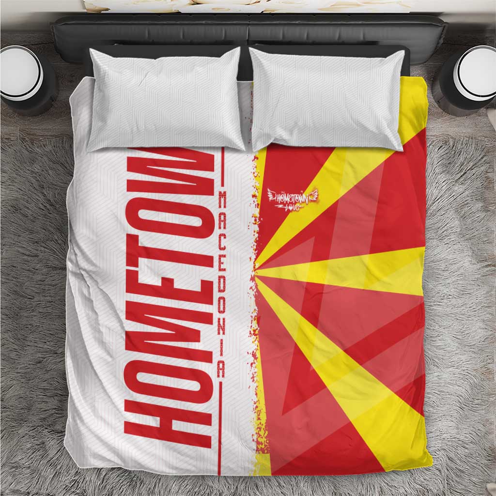 Macedonia bedding set with white pillowcases and quilt featuring flag and map graphic in red, yellow, and black