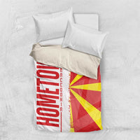 Macedonia bedding set flat lay with white pillows and quilt showing flag rays and vertical map stripe