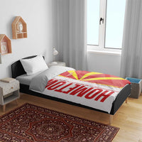 Macedonia flag bedding set on single bed with white pillows and quilt featuring red, yellow, and white design
