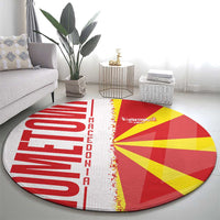 Round Macedonia area rug with red left wordmark, yellow flag rays, and white fringe