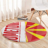 Round red and yellow Macedonia flag rug with white center seam and fringed edge