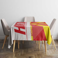 Red and yellow Macedonia flag map tablecloth on dining table with four chairs
