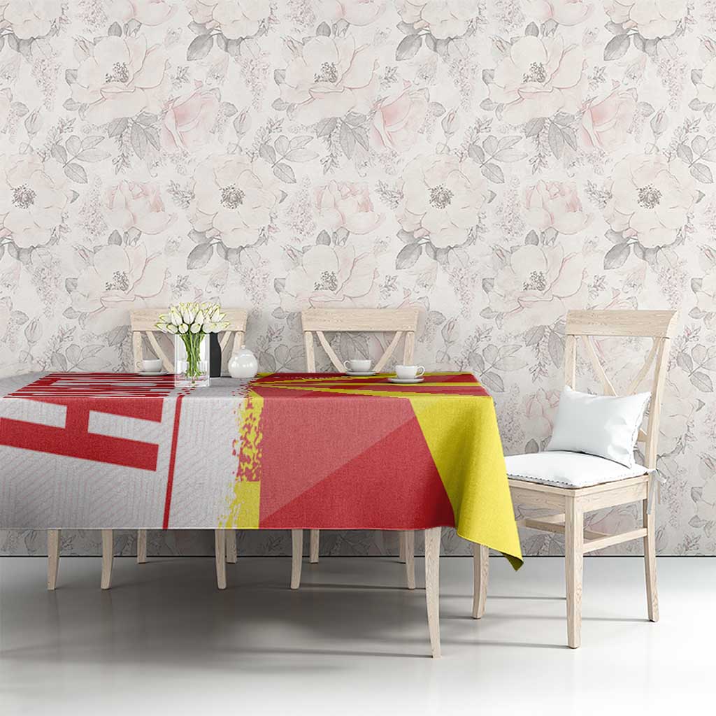 Red and yellow Macedonia flag and map tablecloth on dining table with chairs, wide view
