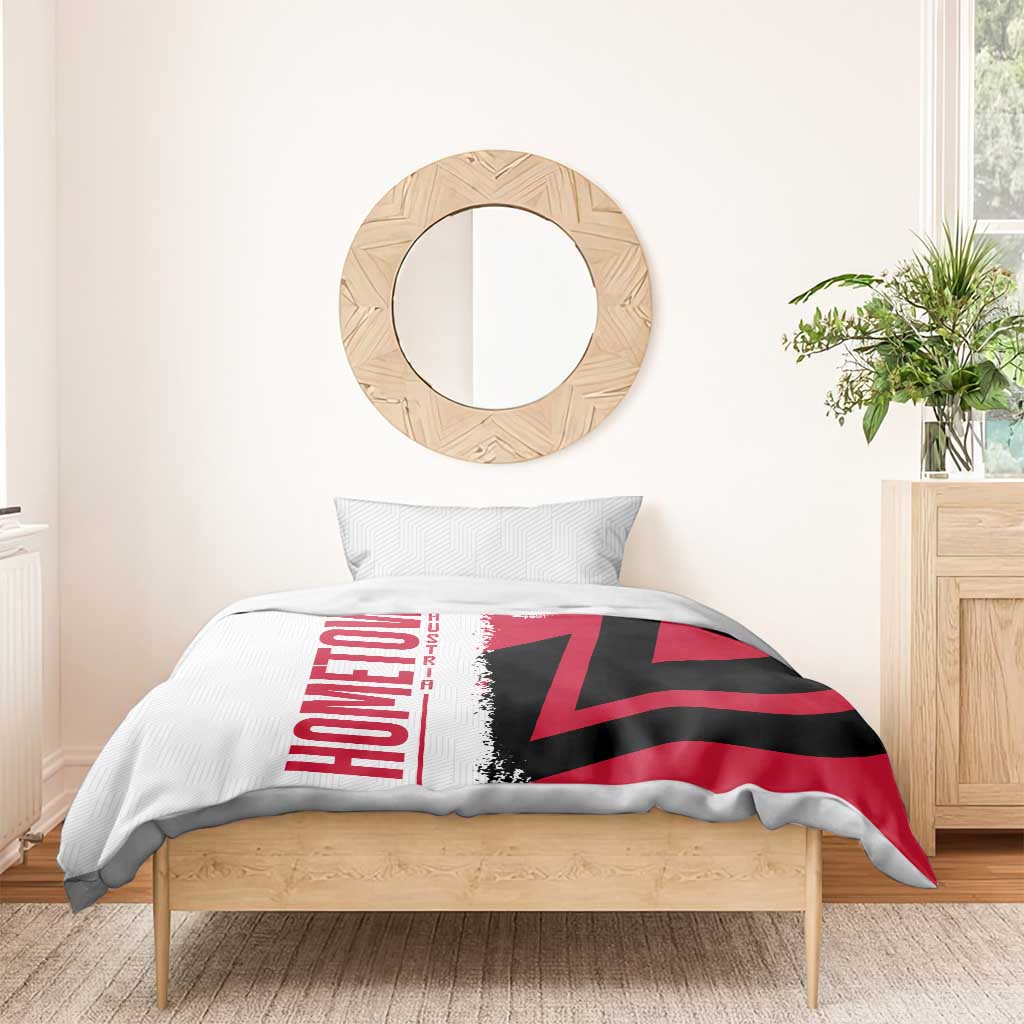 Flag duvet cover with red, black and white print and matching pillowcase on wooden bed