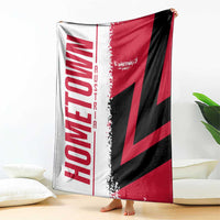 Cuba flag-themed throw blanket with red, black and white diagonal emblem, corner view