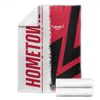 Cuba flag-themed throw blanket, red black and white graphic, folded with white towels