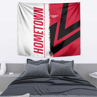 Red, black, and white tapestry flag with diagonal starburst design and vertical word mark