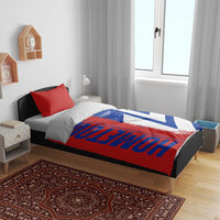 Flag map bedding set in red, blue, and white on a bed with matching pillowcases