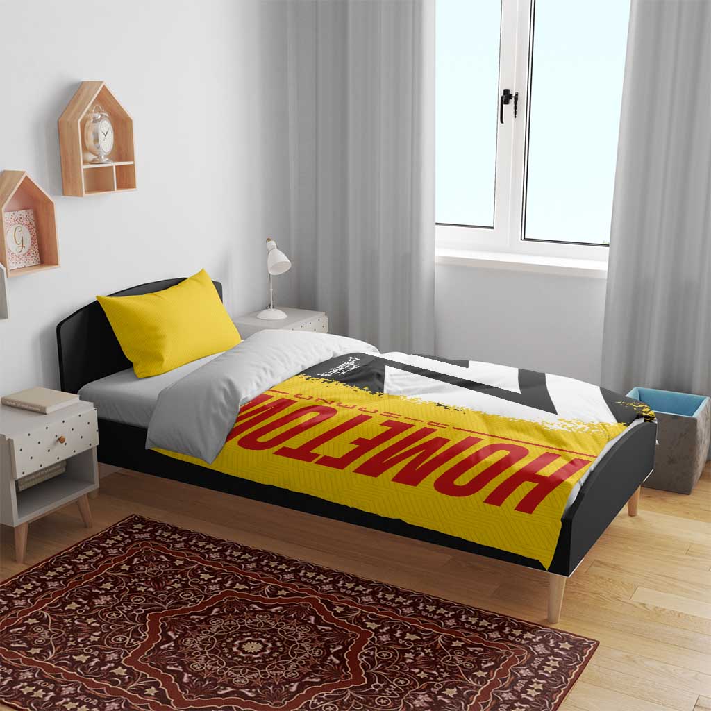 Yellow duvet cover with red "Germany" text and black-white flag design on bed