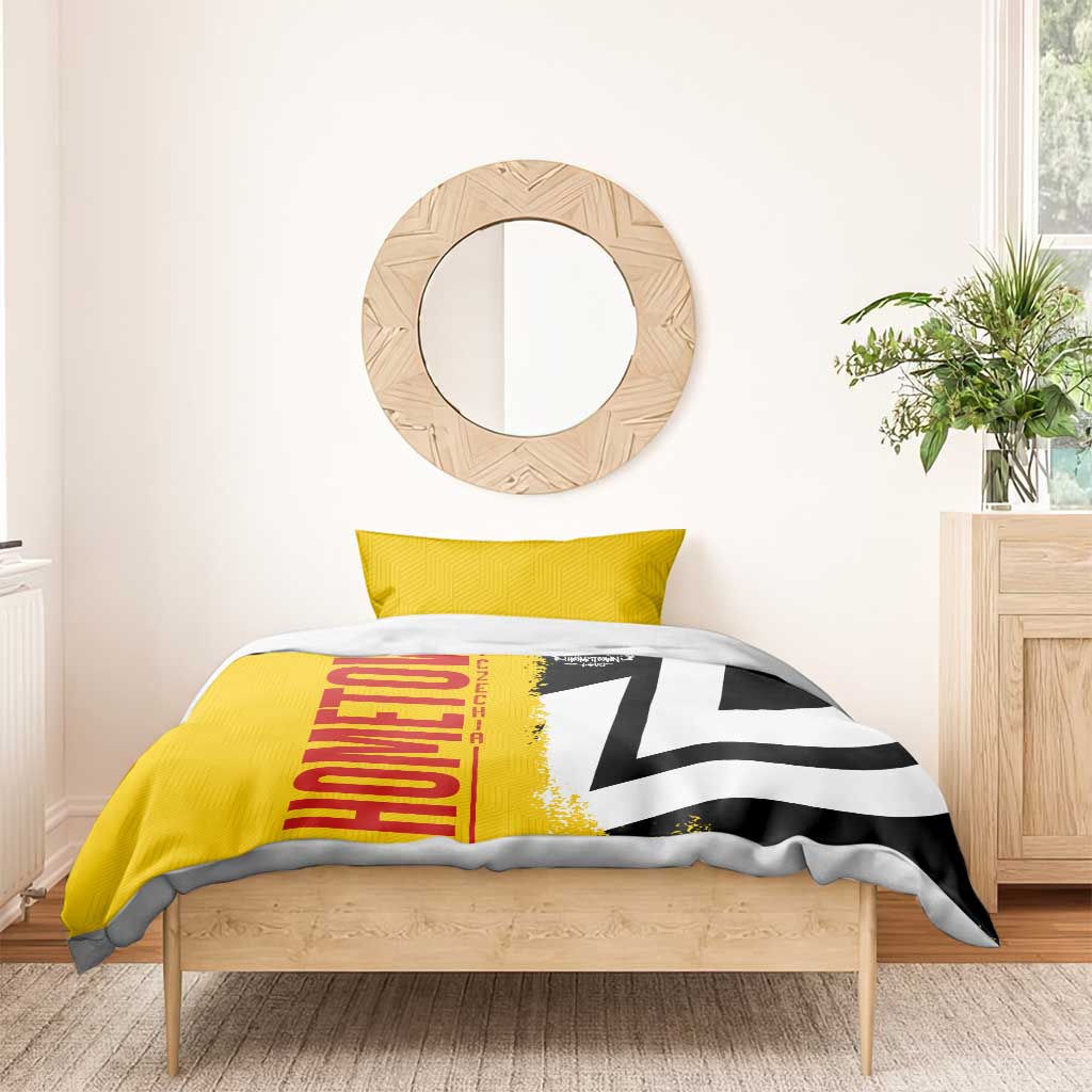 Yellow duvet cover with red "Germany" lettering and black-white flag pattern on bed