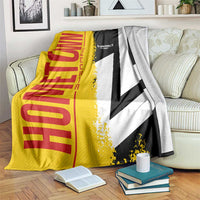 Yellow, red, black and white Germany flag blanket with map graphic, draped on couch