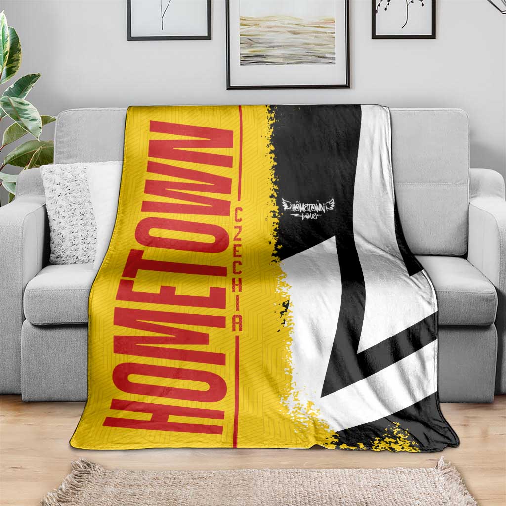 Germany flag blanket in yellow, red, black and white, spread on gray sofa
