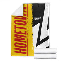 Folded Germany flag blanket in yellow, red, black and white with white cross, stacked