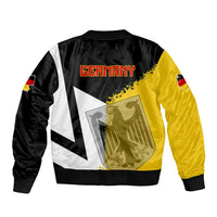 Unisex bomber jacket back view, black with white stripes and yellow Germany map print