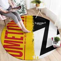 Round Germany flag and map rug with person stepping on it, yellow red black and white graphic