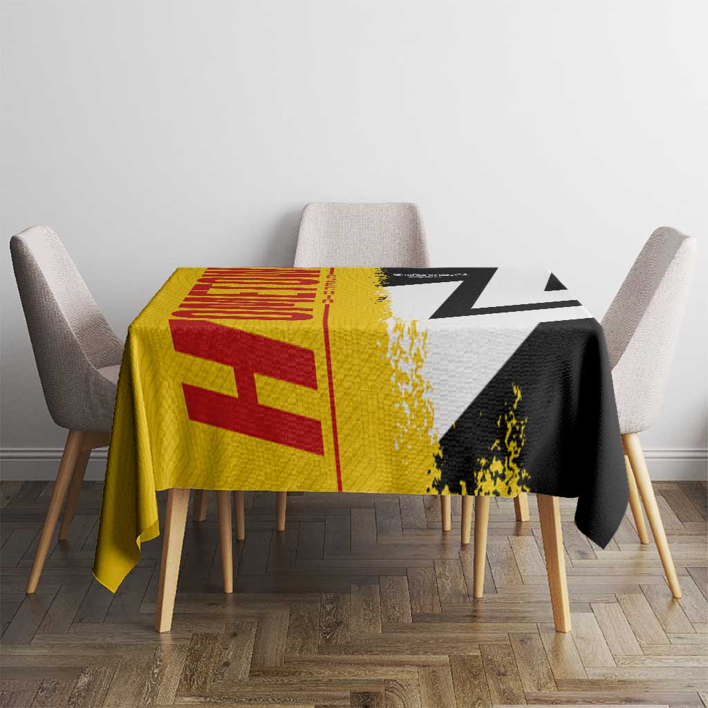 Germany-themed tablecloth on table with chairs, yellow-red panel and black-and-white angular stripe design