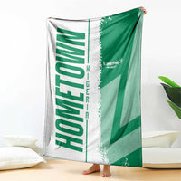 Green and white Nigeria flag and map blanket, spread upright on floor
